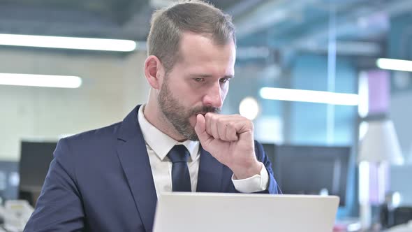 Portrait of Sick Businessman Having Coughing in Office