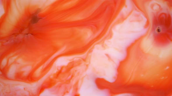  Footage. Ink in Water. Red and Orange Ink Reacting in Water Creating Abstract Background.