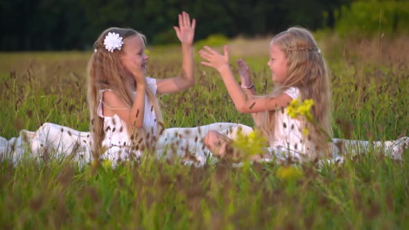 Children Play and Laugh Running Around the Field in Summer