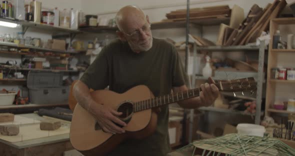 Old man playing a guitar