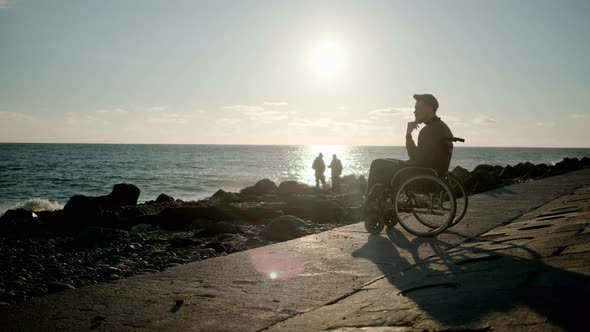 Lonely Adult Disabled Man Is Contemplating Sea View Sitting on Seashore