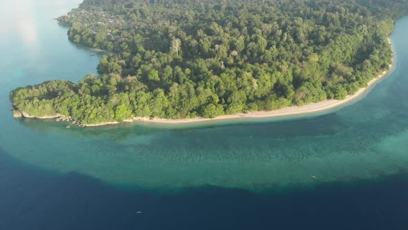 Flying over tropical Ai island white sand beach Banda Islands Maluku Indonesia 