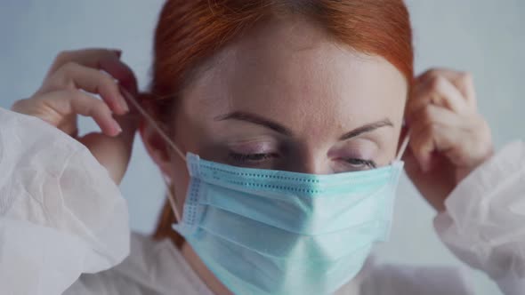 A Tired Nurse Takes Off the Mask.