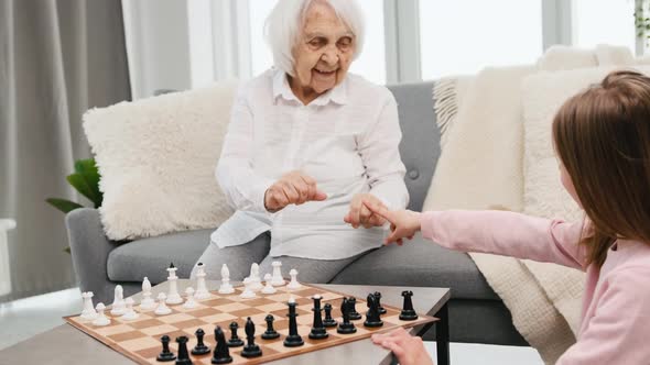 Grandmother Playing Chess with Granddaughter