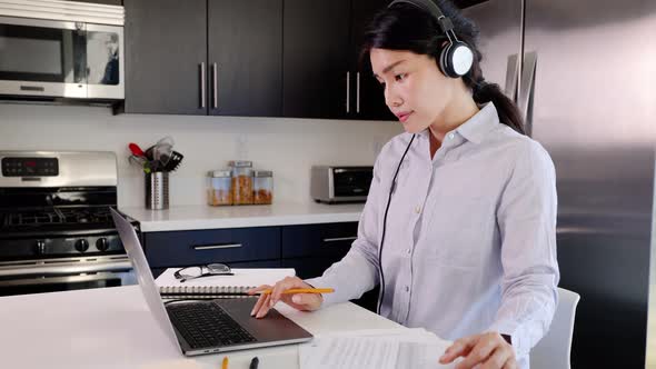 Asian woman paying her bills