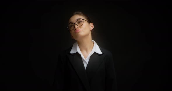 Business Woman with Glasses Shrugs Her Shoulders