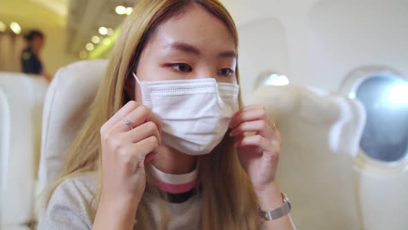 Traveler Wearing Face Mask While Traveling on Commercial Airplane