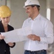 Two architects wearing protective helmet works at building site - VideoHive Item for Sale