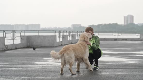 Teenage Boy Giving His Labrador Dog Affection