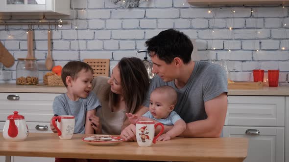 Big Happy Family Enjoying Evening Tea in Kitchen