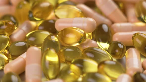 Mix of vitamin B complex capsules and omega 3 pills close-up