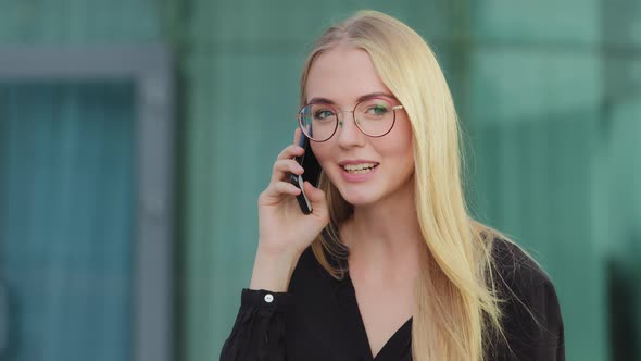 Happy Young Woman in Glasses Caller Talking on Phone Outdoor Cheerful Millennia Girl Enjoys Pleasant