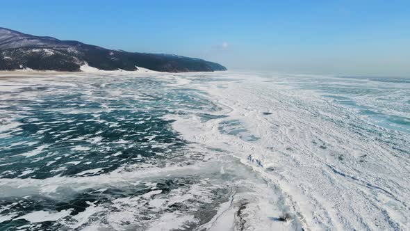 Flying over Lake Baikal on frosty, clear day. Snow and ice form a patterned grid