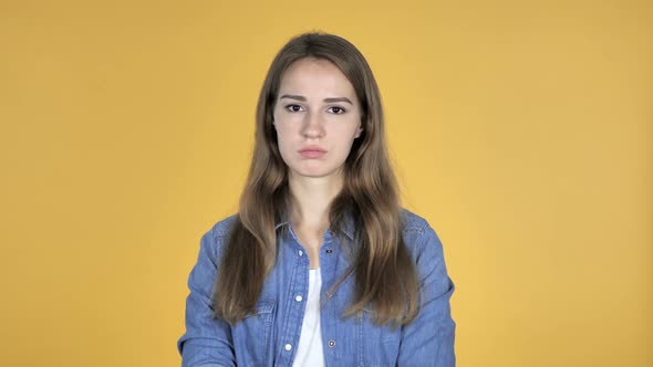 Pretty Woman Shaking Head To Reject Isolated on Yellow Background