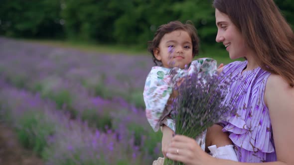 Mother Enjoying Time with Baby Girl in Lavender Field