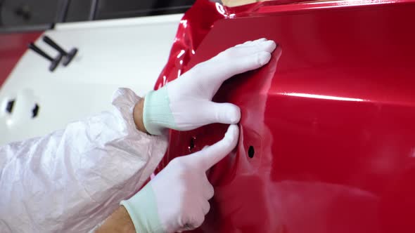 Man Is Smoothing Protective Vinyl Tape on Car Body
