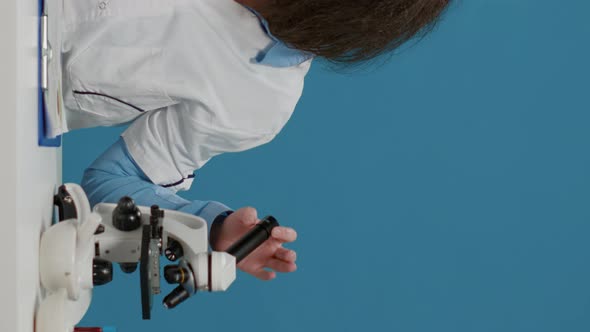 Vertical Video Crazy Foolish Chemist Using Lab Microscope Over Background