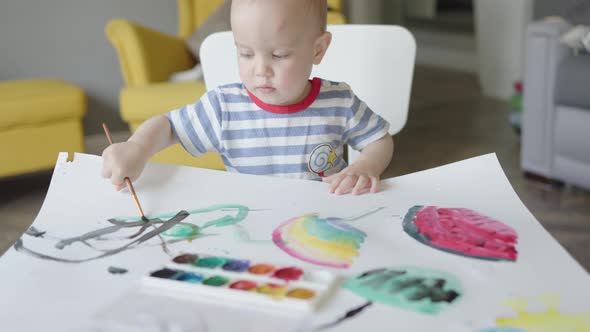 Baby Child Boy Kid Learning to Paint Using Paintbrush and Aquarelle Home Class
