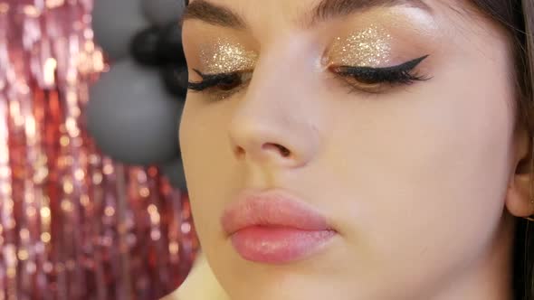 Brush Applies Foundation to the Face of a Beautiful Young Model for Evening Makeup Smoky Eyes