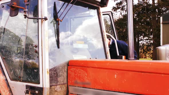 Cattle farmer getting in the tractor