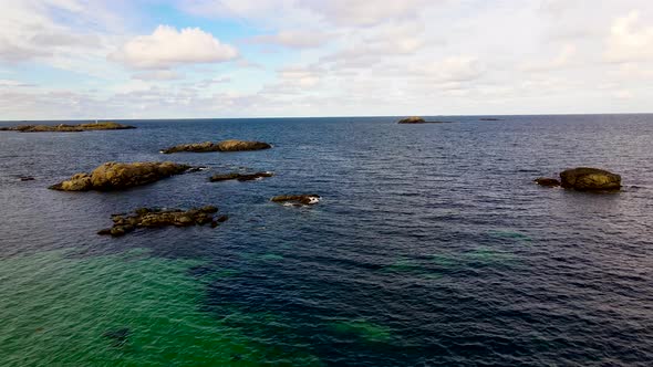 AERIAL: Small islands in the crystal clear arctic ocean