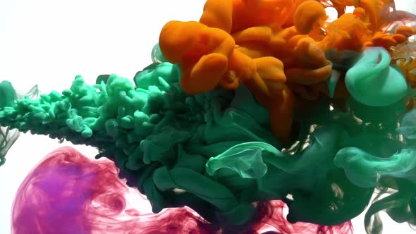 Orange, green and purple ink paint colliding