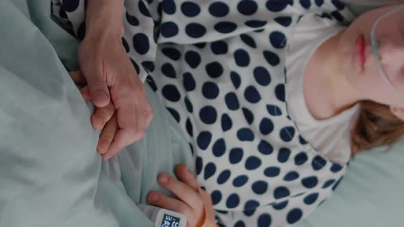 Vertical Video Close Up of Mother Holding Sick Kid Daughter Hands Waiting for Illness Treatment