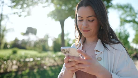 Smiling brunette woman looking at mobile