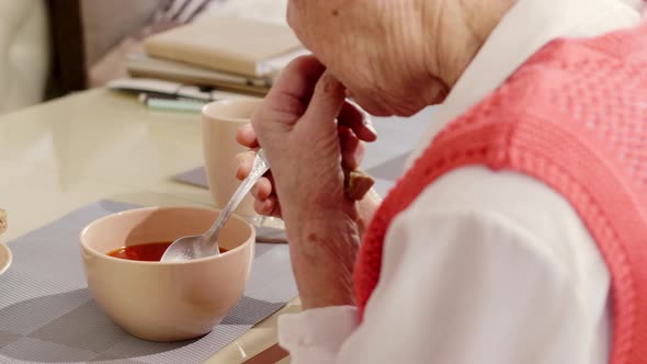 Close-Up of Elderly Woman Eating Soup