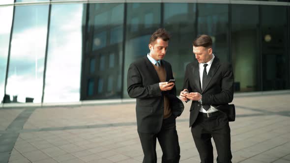 Businessman Communicating with Mobile Smart Phones