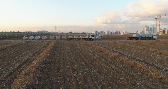 Aerial view of a tractor loading cotton bales on truck, Israel.