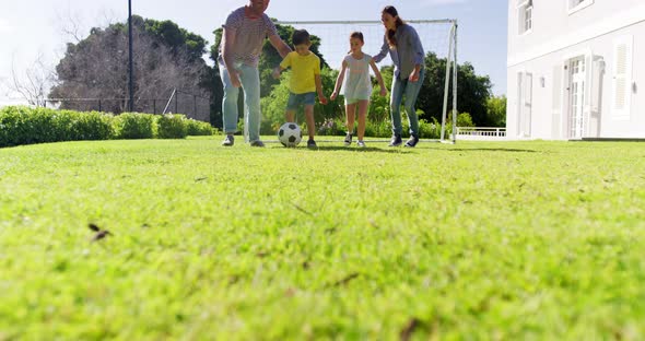 Happy family playing football