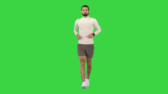 Handsome Confident Male Runner Jogging on a Green Screen Chroma Key