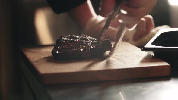 Restaurant Cooking  Chef Puts a Piece of Meat on the Board