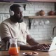 Freelancer Programmer in Headphones Working From Home on Kitchen and Using Laptop - VideoHive Item for Sale