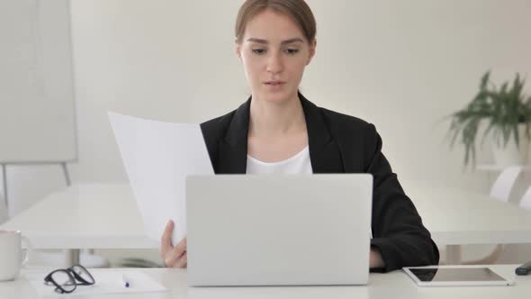 Paperwork Young Businesswoman Working on Documents and Laptop