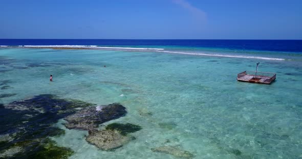 Wide above abstract view of a summer white paradise sand beach and aqua turquoise water background 