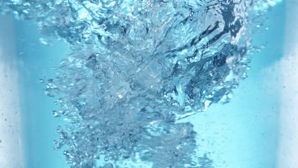 Super Slow Motion Shot of Water Whirl on Light Blue Background at 1000Fps alt