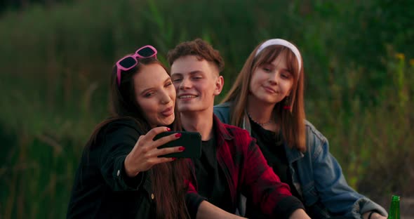 Group of Friends Enjoying Good Time Taking Selfies on the Smartphone