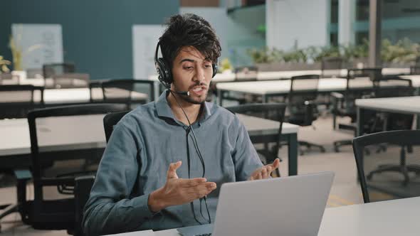 Young Arabian Male Worker Operator Business Man in Headphones with Microphone Use Laptop Talk with