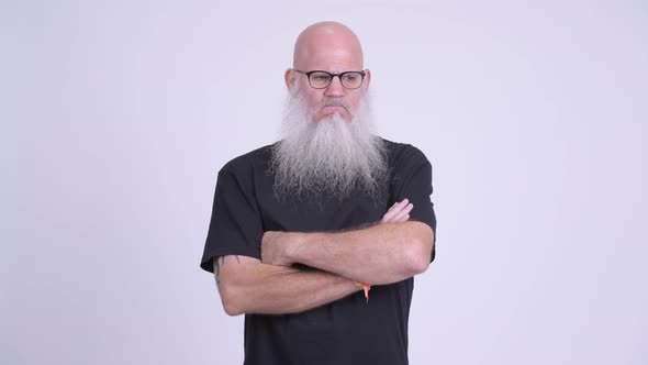 Angry Mature Bald Bearded Man in Rage with Arms Crossed