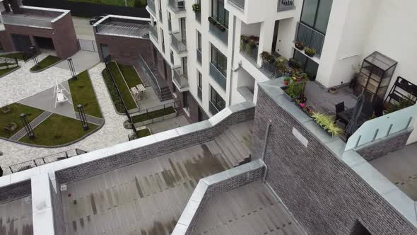 Aerial view of a drone flying over the residential buildings, roof shooting and architecture.