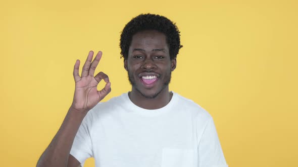 Okay Sign By African Man Yellow Background