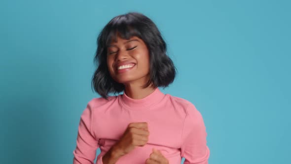 Happy Young Woman Makes Triumph Gesture Says Yes I Did It Makes Victory Dance