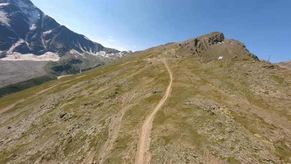 Aerial View Nature Cliff Peak with Paths and Clear Blue Sky Ski Resort Landscape at Summer