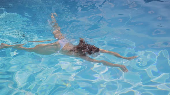 Sexy Woman Swims in a Pool