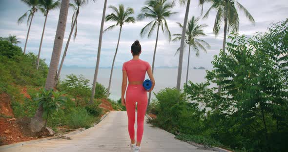Woman Walking Down the Road Through the Tropical Forest for Her Evening Exercise / Videohive, Stock footage, Sports