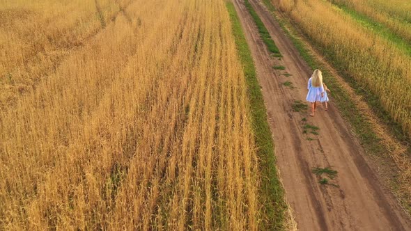 Little Daughter and Mom Walk Around Field