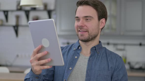 Portrait of Beard Young Man Doing Video Chat on Tablet