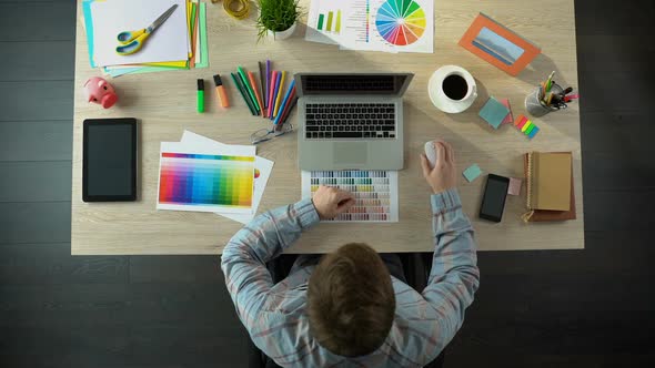 Interior Designer Working on Computer, Creatively Decorating Apartment, Top View